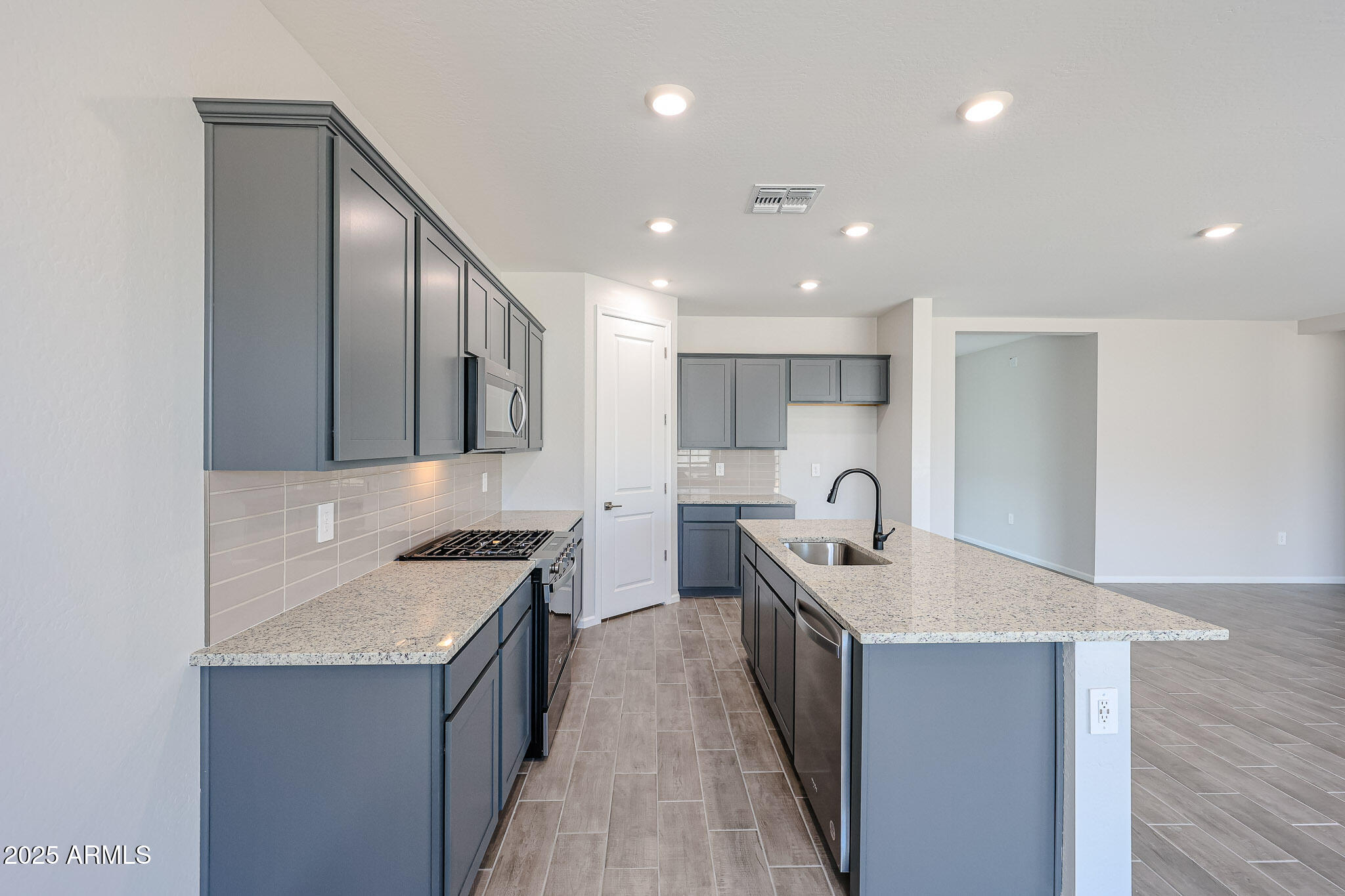 17867 West Fulton Street Goodyear, AZ 85338 - Photo 5 of 40 a kitchen with a sink stove and cabinets