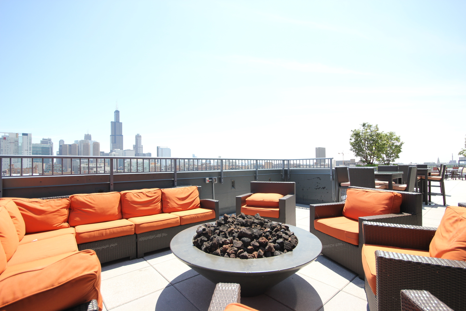 1164 West Madison Street, Unit 309 Chicago, IL 60607 - Photo 13 of 18 a blue couch sitting on top of a roof with a couch