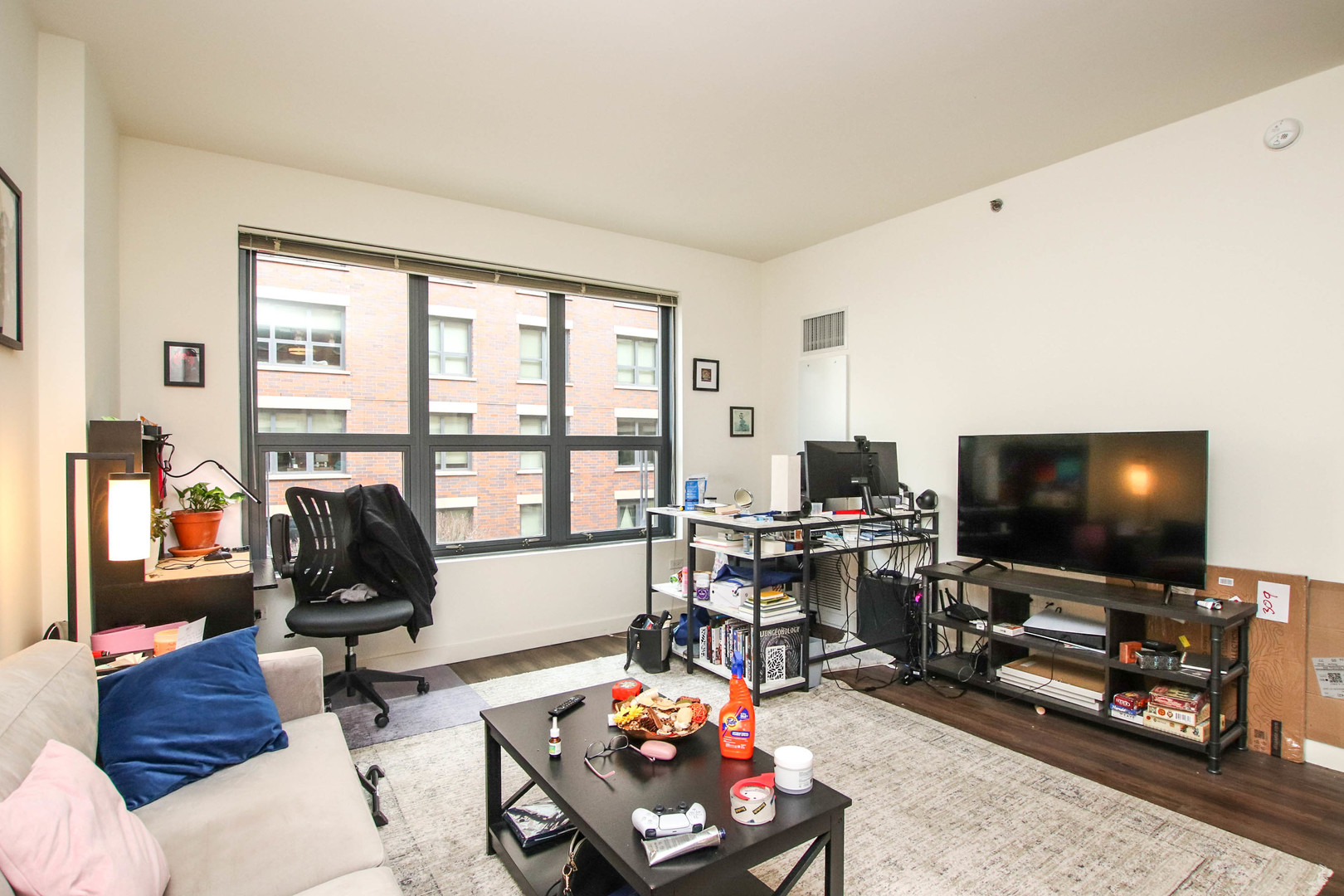 1164 West Madison Street, Unit 309 Chicago, IL 60607 - Photo 3 of 18 a living room with furniture and a flat screen tv