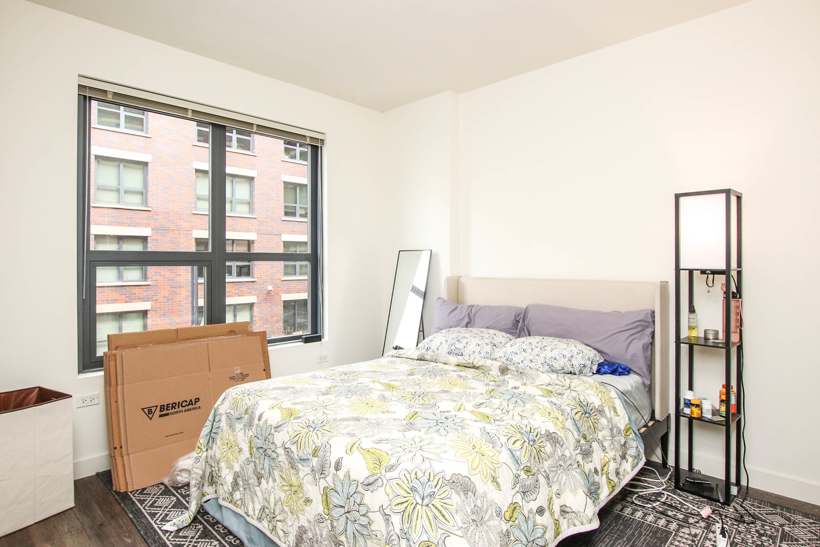 1164 West Madison Street, Unit 309 Chicago, IL 60607 - Photo 6 of 18 a bedroom with a bed and a large window