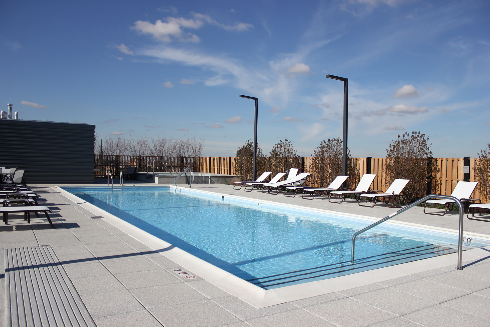1164 West Madison Street, Unit 309 Chicago, IL 60607 - Photo 9 of 18 a view of a swimming pool and lounge chairs