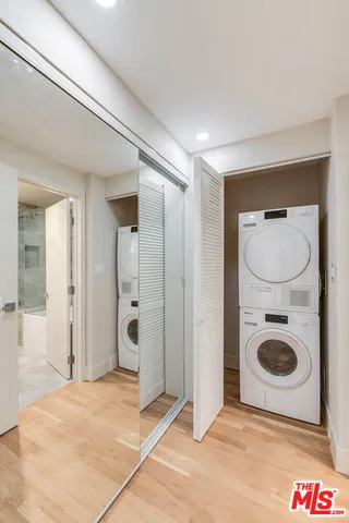 a view of a hallway with washer and dryer