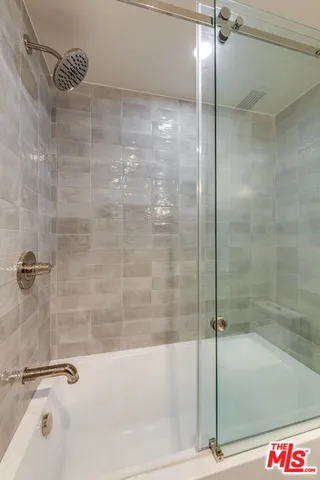 a bathroom with a bathtub and a shower
