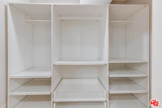 a living room with patio furniture and a chandelier