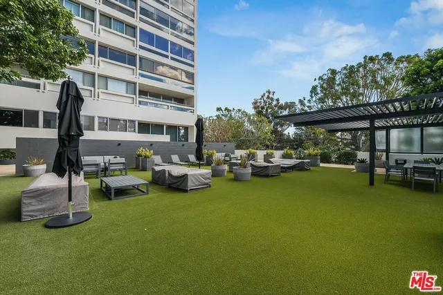 a view of a room with wooden floor and windows