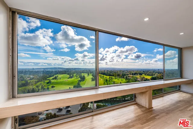 a view of a living room and a floor to ceiling window