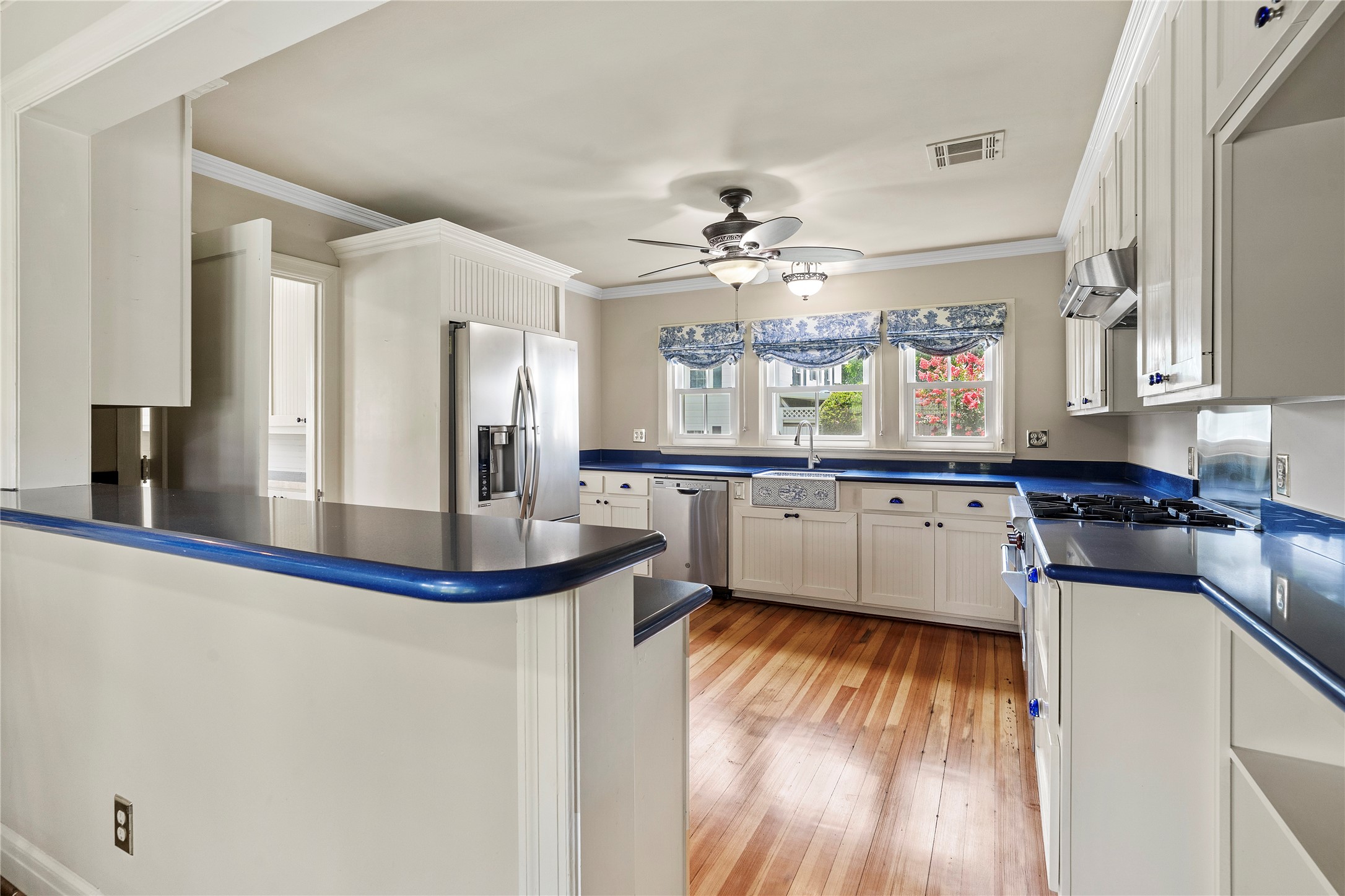 9827 FM 2759 Road Richmond, TX 77469 - Photo 16 of 50 a kitchen with stainless steel appliances a sink cabinets and wooden floor