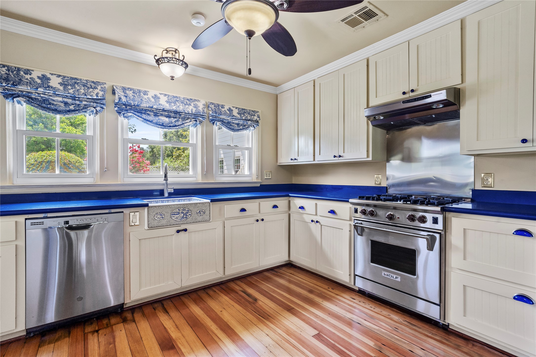 9827 FM 2759 Road Richmond, TX 77469 - Photo 18 of 50 a kitchen with stainless steel appliances granite countertop a stove a sink and a microwave with wooden floor