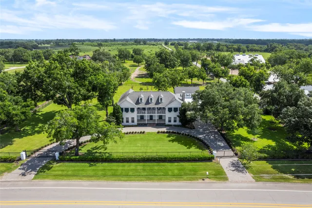 a view of a swimming pool with lawn chairs under an umbrella