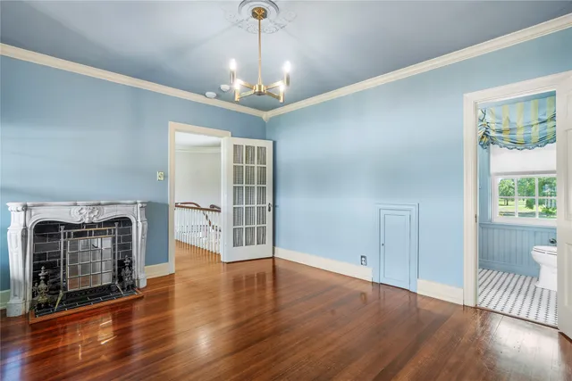 a view of a livingroom with wooden floor and a ceiling fan