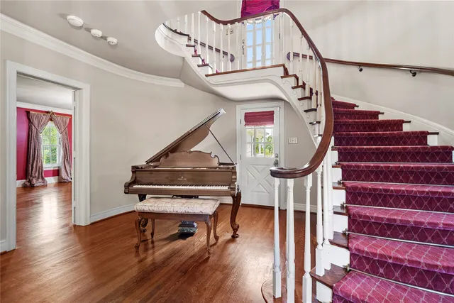 a view of entryway and hall with wooden floor