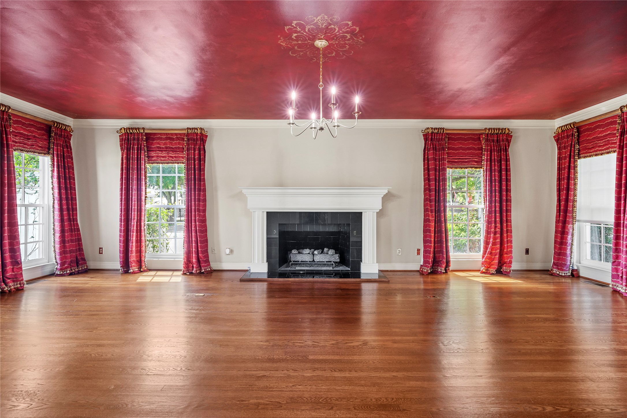 9827 FM 2759 Road Richmond, TX 77469 - Photo 7 of 50 an empty room with wooden floor fireplace and windows