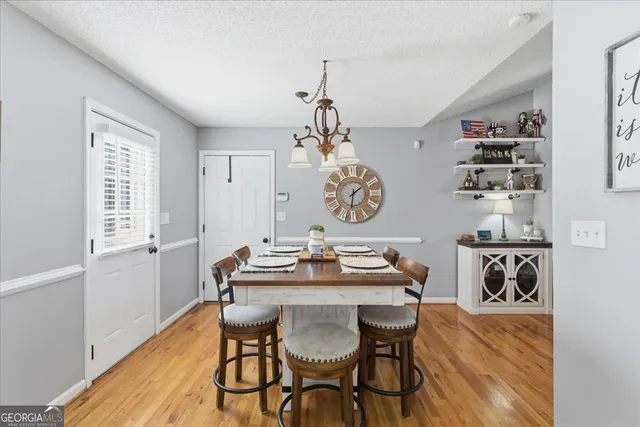 a view of a dining room with furniture and wooden floor