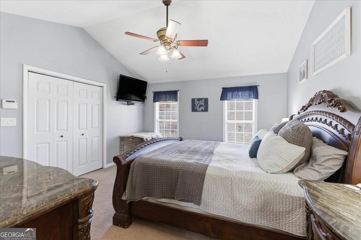 1111 Old Collard Valley Road Aragon, GA 30104 - Photo 19 of 38 a bedroom with a bed and a flat screen tv
