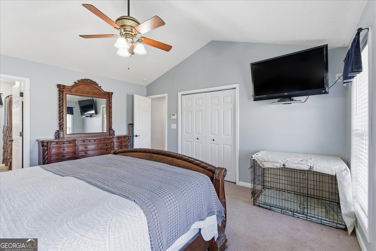 1111 Old Collard Valley Road Aragon, GA 30104 - Photo 20 of 38 a bedroom with a bed a window and a flat screen tv