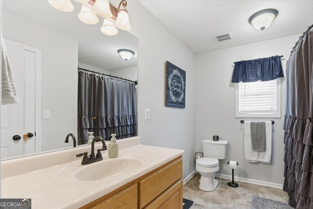 1111 Old Collard Valley Road Aragon, GA 30104 - Photo 21 of 38 a bathroom with a sink a toilet and mirror