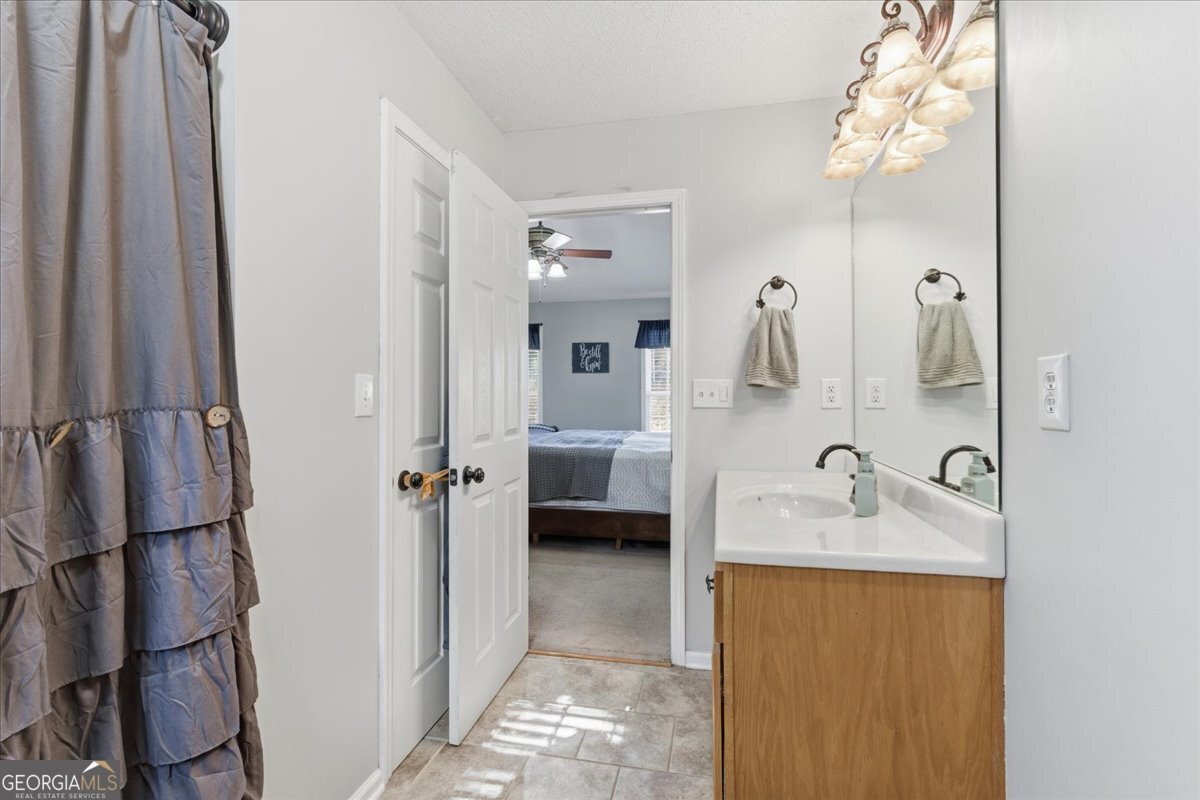 1111 Old Collard Valley Road Aragon, GA 30104 - Photo 22 of 38 a en suite bathroom with a granite countertop sink and a mirror