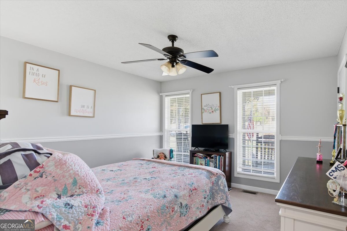 1111 Old Collard Valley Road Aragon, GA 30104 - Photo 23 of 38 a bedroom with a bed and a flat screen tv