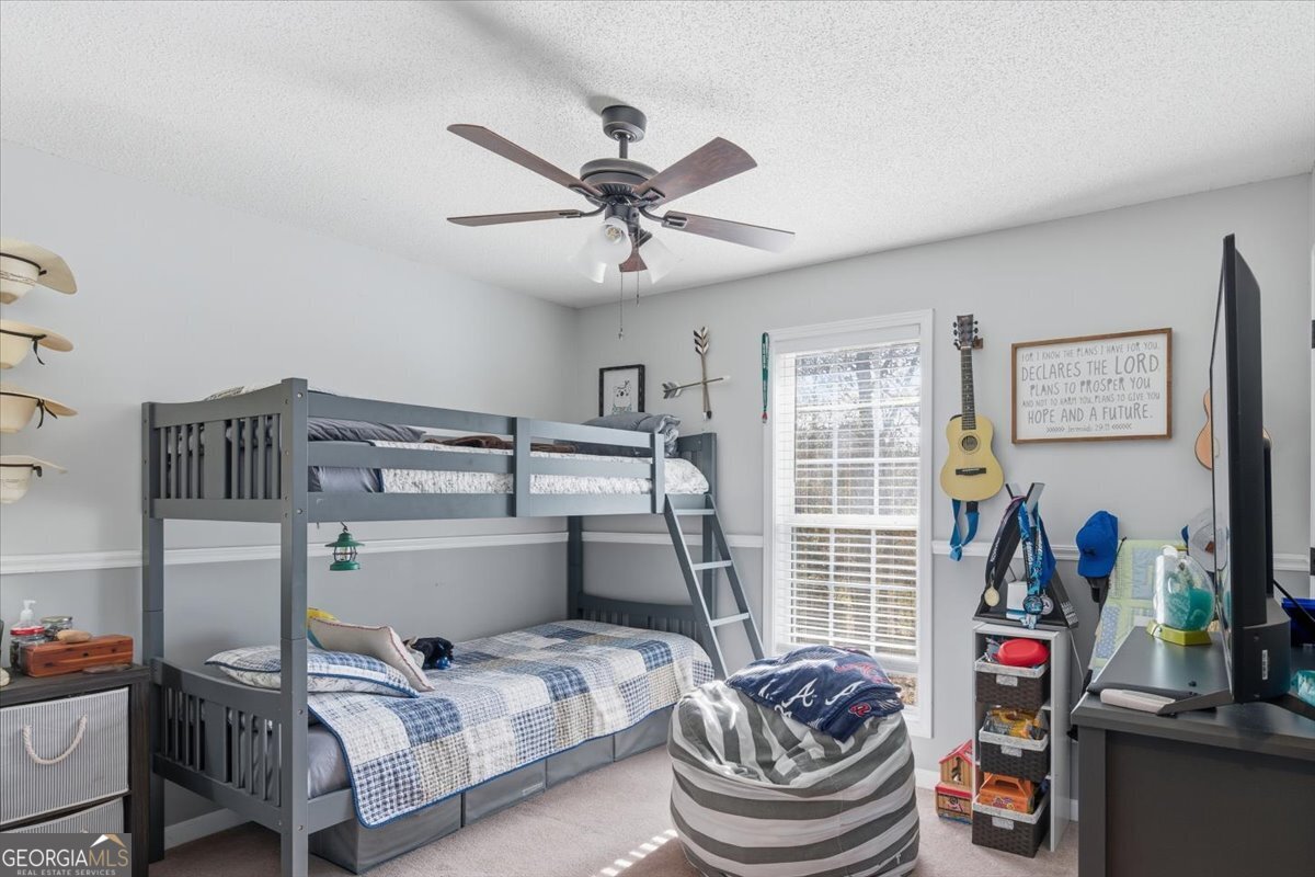 1111 Old Collard Valley Road Aragon, GA 30104 - Photo 25 of 38 a bedroom with a bed and a chandelier