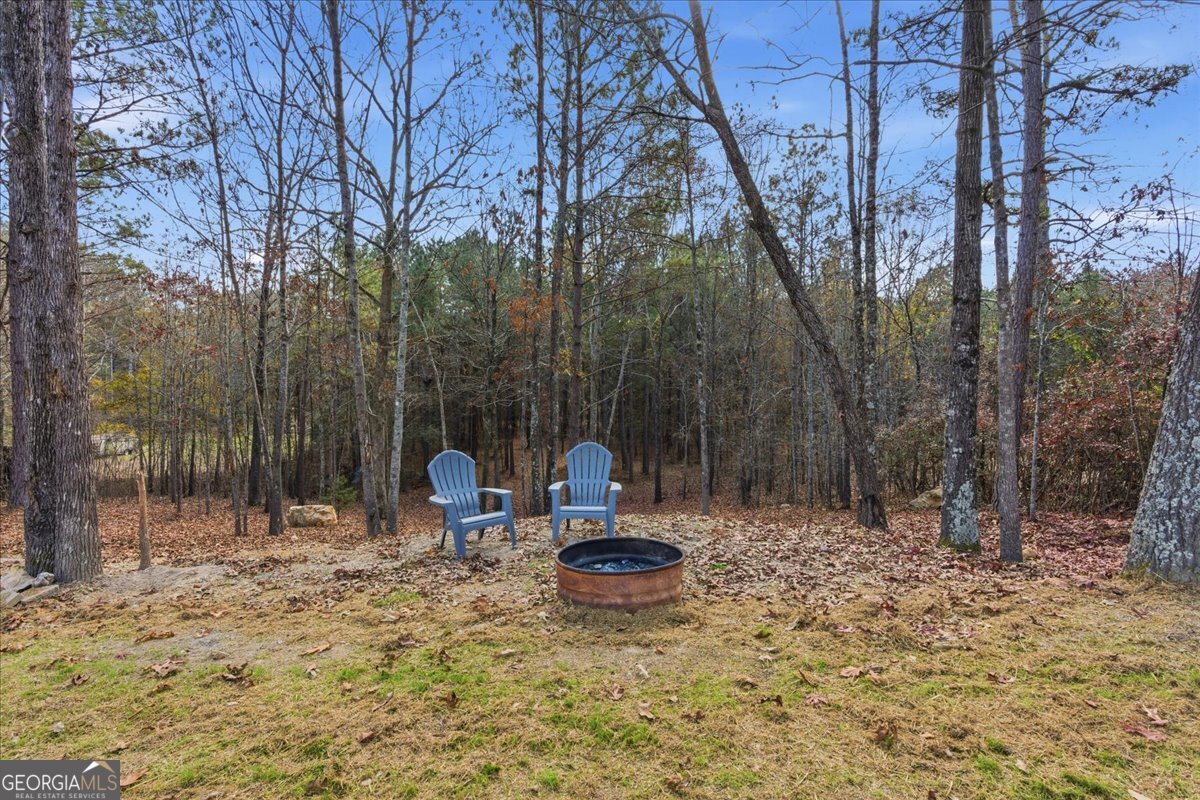 1111 Old Collard Valley Road Aragon, GA 30104 - Photo 32 of 38 a backyard of a house with table and chairs