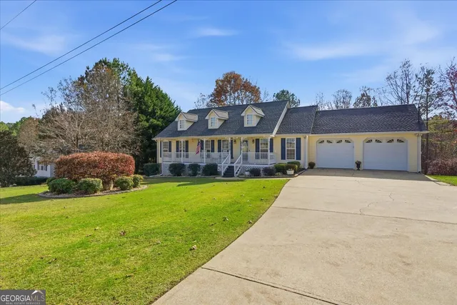 a front view of a house with a garden