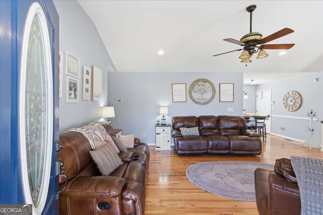 a living room with furniture a clock and a window