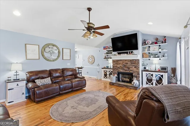a living room with fireplace furniture and a flat screen tv