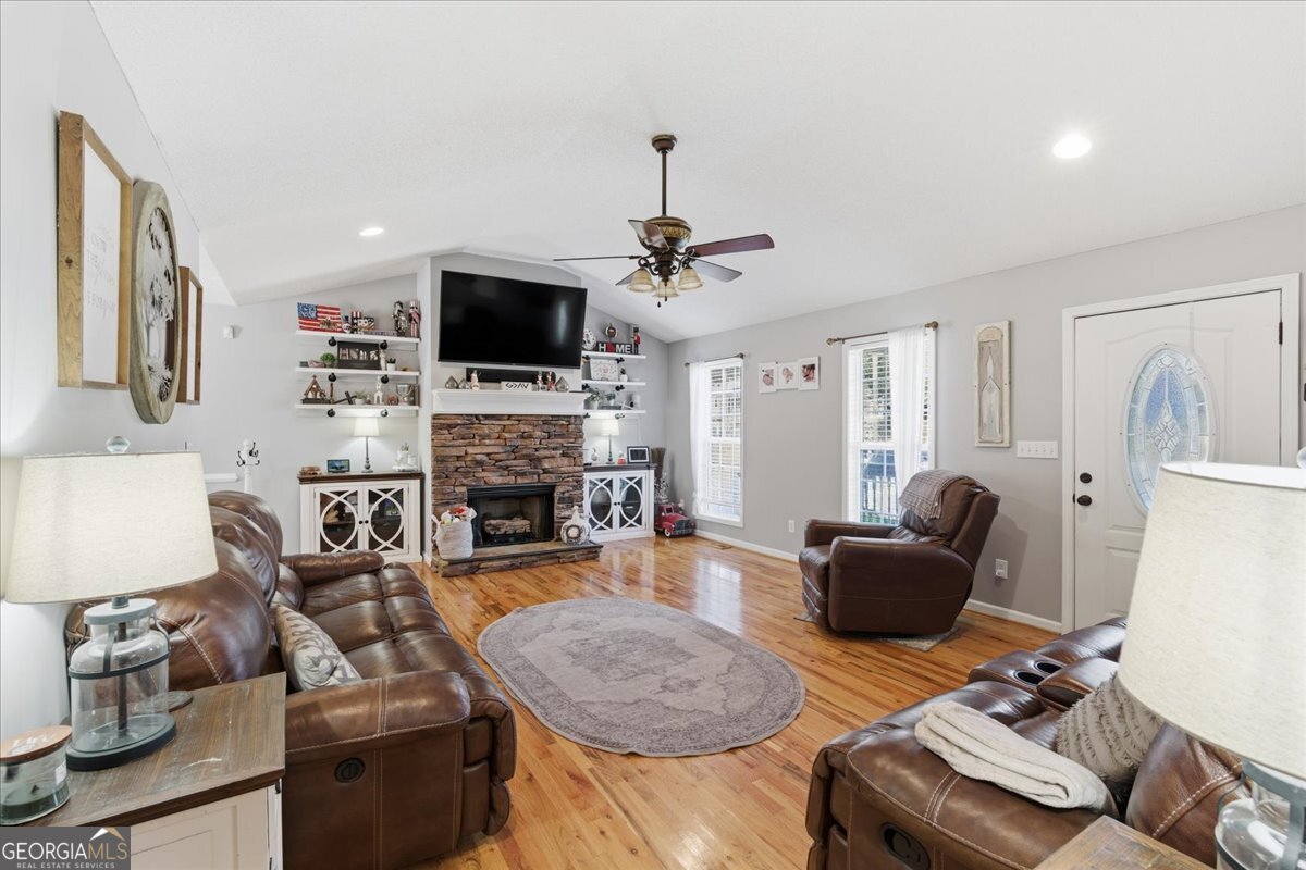 1111 Old Collard Valley Road Aragon, GA 30104 - Photo 9 of 38 a living room with furniture a flat screen tv and a fireplace