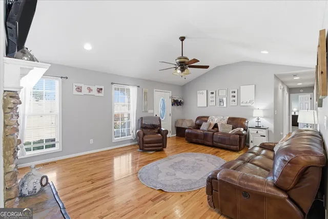 a living room with furniture and a wooden floor