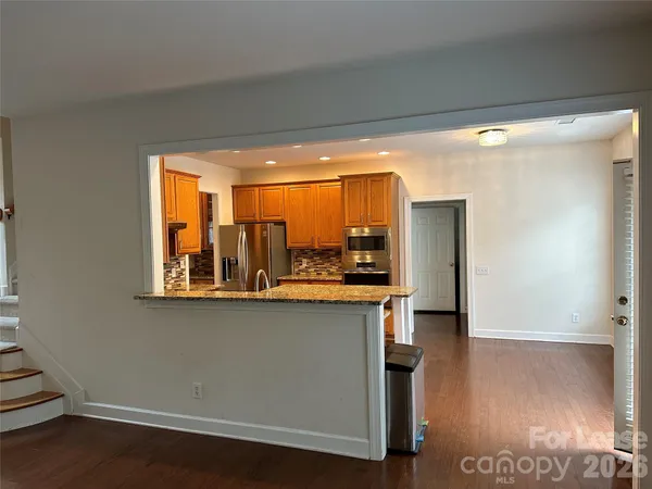 a kitchen with stainless steel appliances a large counter top a stove and a refrigerator