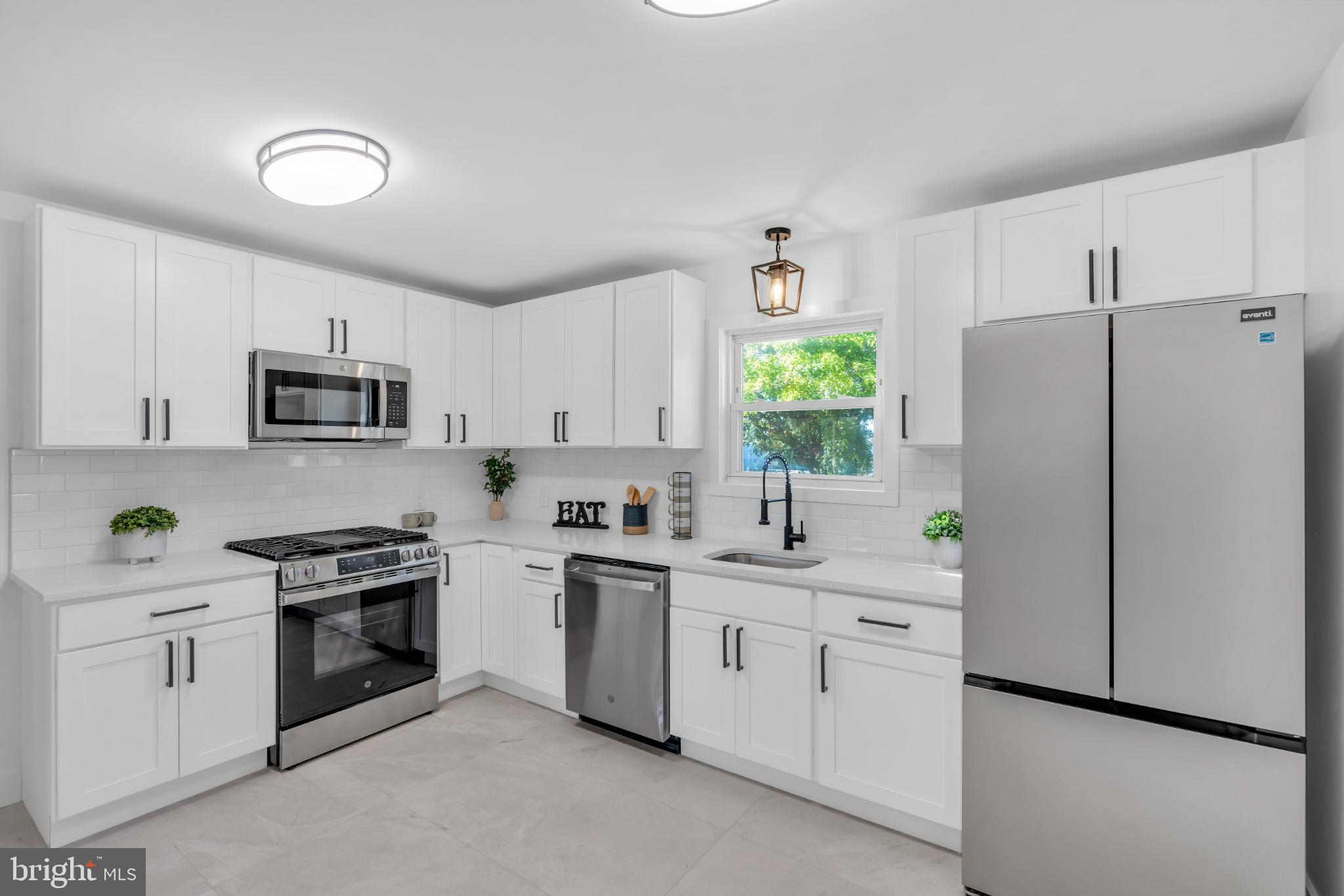 104 East Laurelton Avenue Maple Shade, NJ 08052 - Photo 9 of 37 a kitchen with white cabinets and white appliances