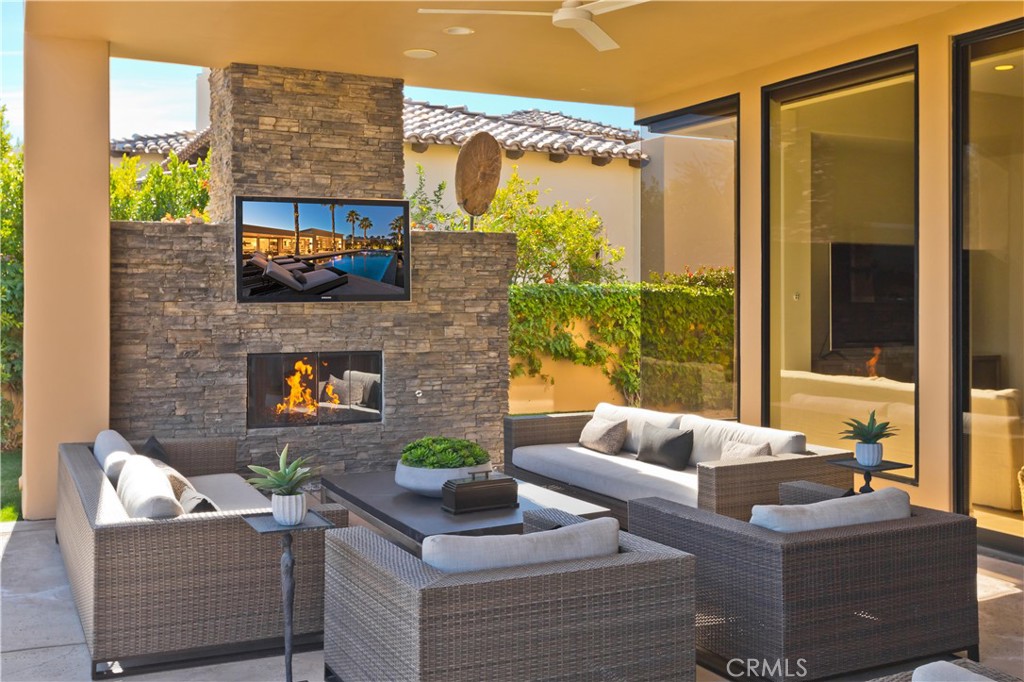 57780 Troon Way La Quinta, CA 92253 - Photo 14 of 67 a living room with fireplace furniture and a floor to ceiling window