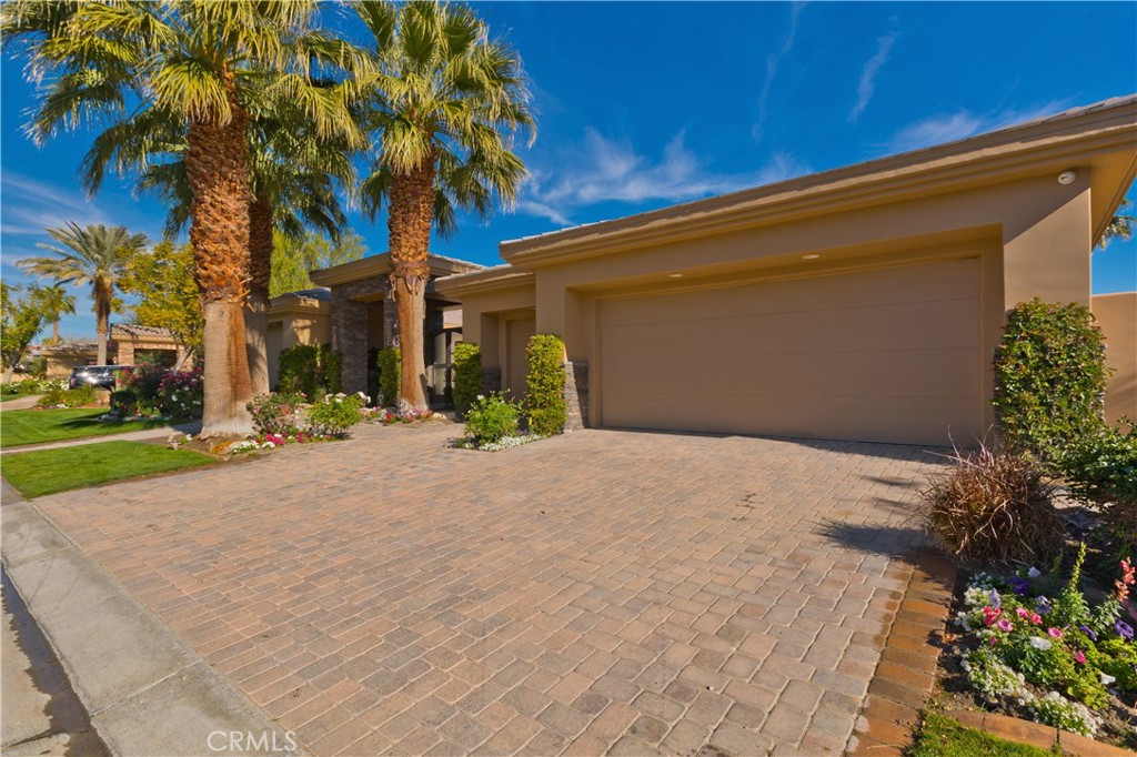 57780 Troon Way La Quinta, CA 92253 - Photo 17 of 67 a front view of a house with a yard and a garage