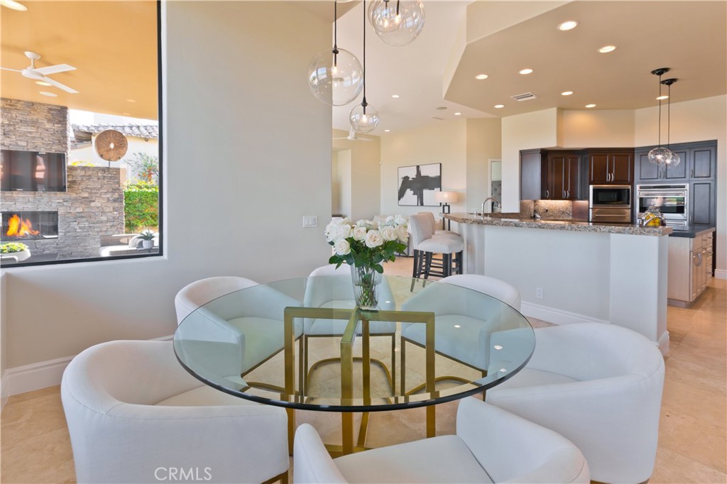 57780 Troon Way La Quinta, CA 92253 - Photo 22 of 67 a dining room with furniture a window and kitchen view
