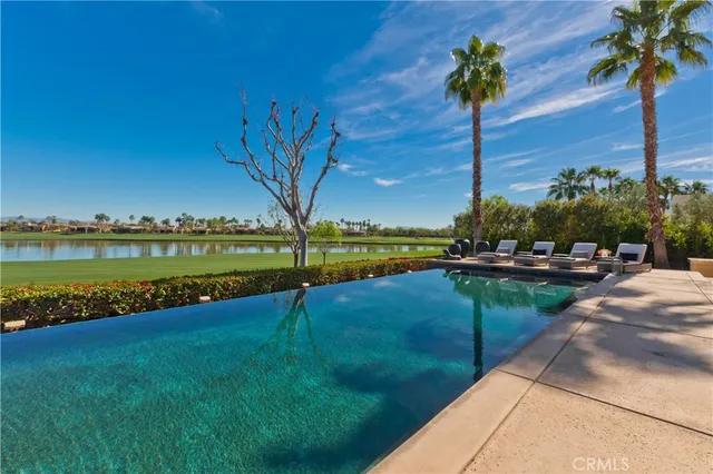 a living room with furniture a floor to ceiling window and a flat screen tv