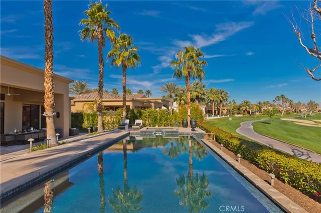 a living room with furniture a large window and a flat screen tv