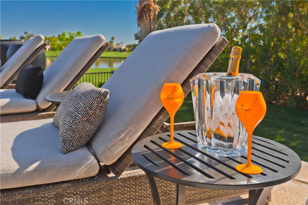 57780 Troon Way La Quinta, CA 92253 - Photo 3 of 67 a view of a swimming pool with a chairs and table in the patio