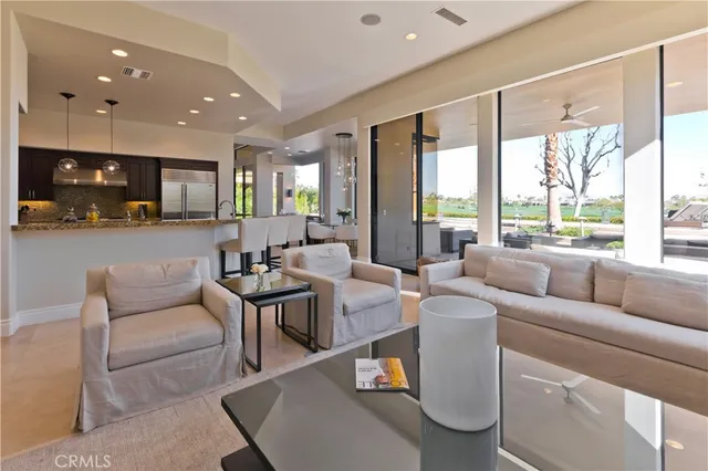 a living room with furniture and a floor to ceiling window