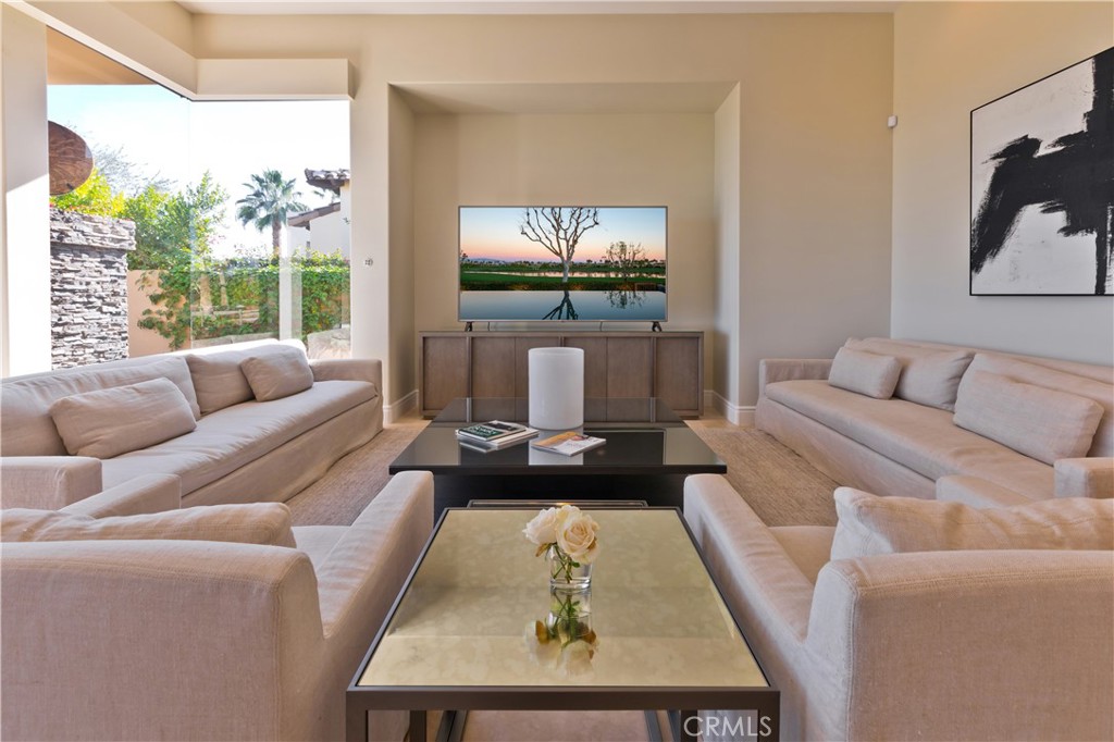 57780 Troon Way La Quinta, CA 92253 - Photo 34 of 67 a living room with furniture a large window and a flat screen tv