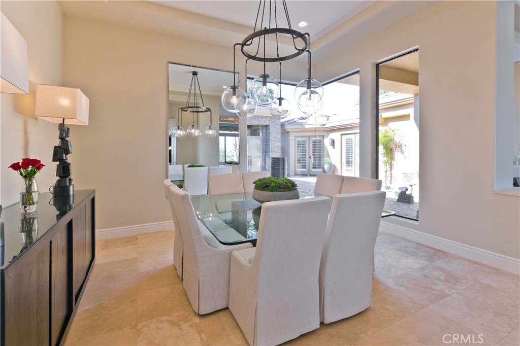 57780 Troon Way La Quinta, CA 92253 - Photo 35 of 67 a dining room with chandelier and wooden floor