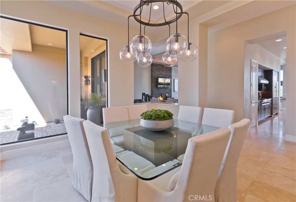 57780 Troon Way La Quinta, CA 92253 - Photo 36 of 67 a view of a dining room with furniture a chandelier and wooden floor