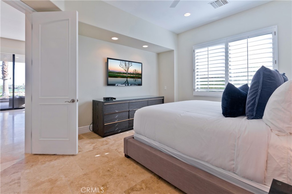 57780 Troon Way La Quinta, CA 92253 - Photo 38 of 67 a bedroom with a bed and a flat screen tv