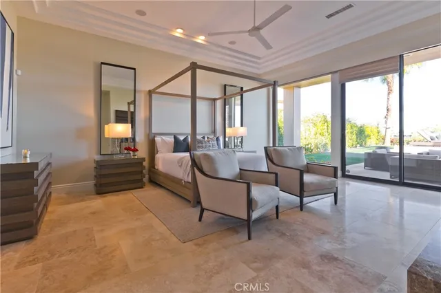 a spacious bedroom with a bed and a lamp