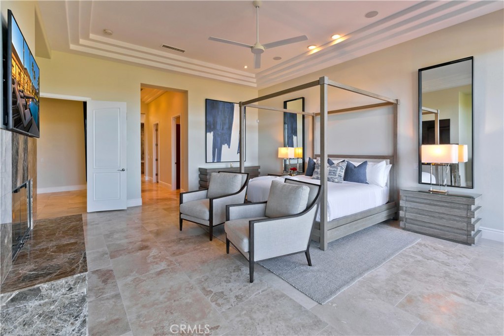 57780 Troon Way La Quinta, CA 92253 - Photo 45 of 67 a spacious bedroom with a bed and a chandelier