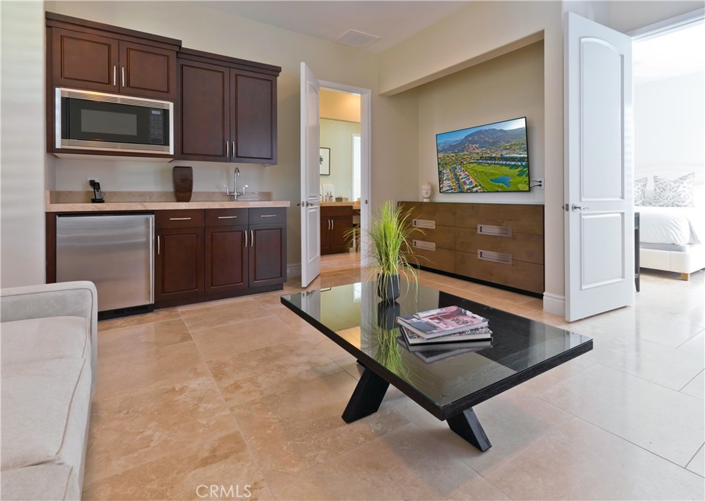57780 Troon Way La Quinta, CA 92253 - Photo 55 of 67 a living room with stainless steel appliances kitchen island granite countertop furniture and a wooden floor