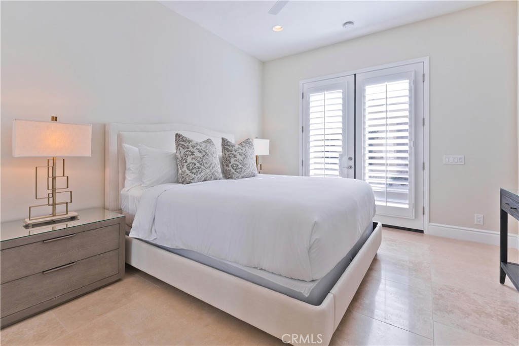 57780 Troon Way La Quinta, CA 92253 - Photo 57 of 67 a spacious bedroom with a bed and a lamp