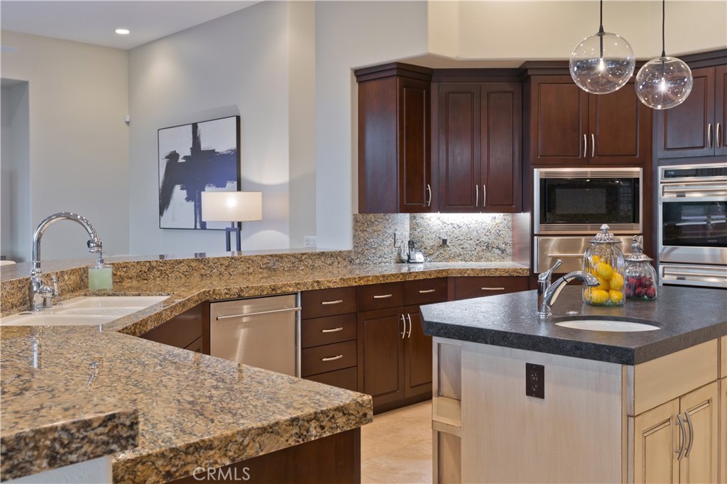 57780 Troon Way La Quinta, CA 92253 - Photo 61 of 67 a kitchen with a sink stove and microwave