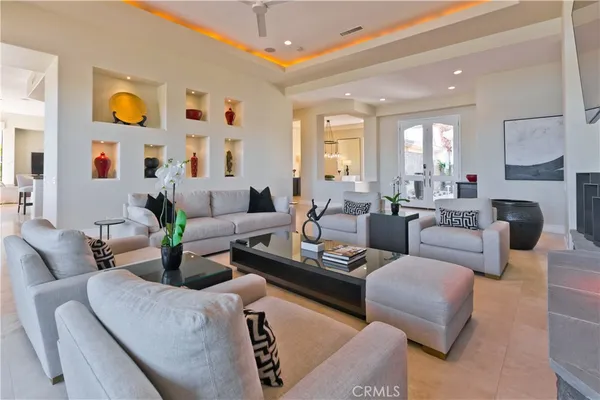 a living room with furniture fireplace and a large window