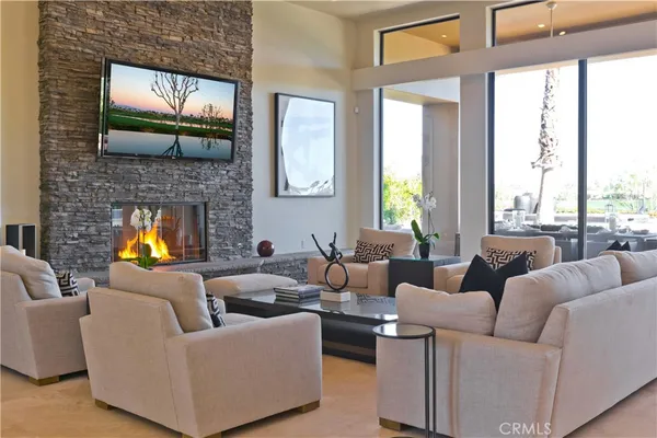 a living room with couch and a floor to ceiling window