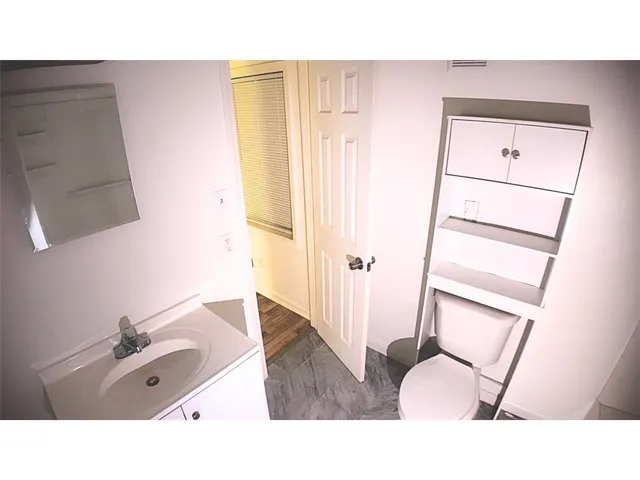 a bathroom with a tub sink and a mirror